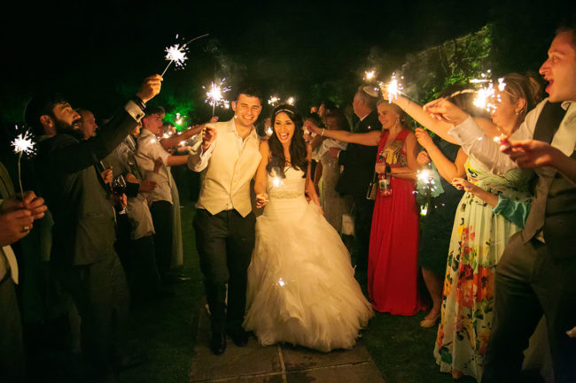 Braxted Park wedding – 1 a bride & groom walk through a sparkler exit at Braxted Park