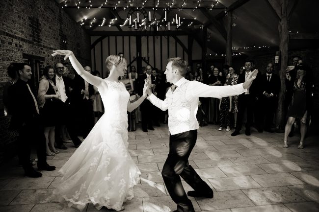 Upwaltham Barns Wedding Photography – 1 a bride & groom doing their first dance at Upwaltham Barns