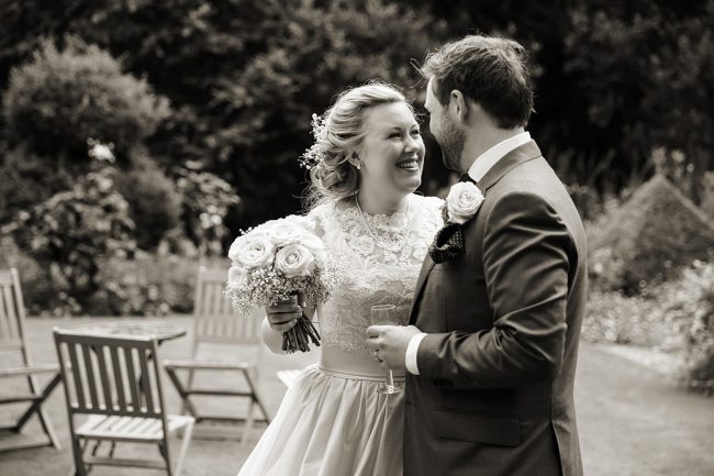 Findon-Manor-wedding-1 bride smiling at her groom
