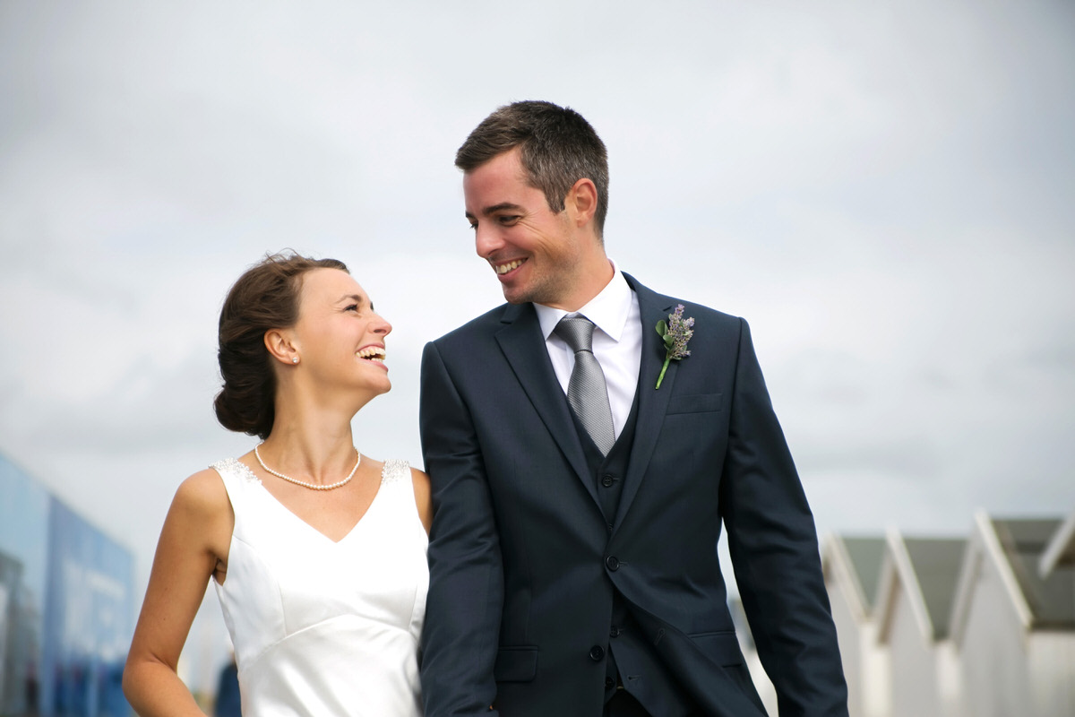 Sussex wedding photographer – 1 a bride & groom walking on the beach