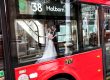 the bride & groom outside Old Finsbury Town Hall reflected in a bus window