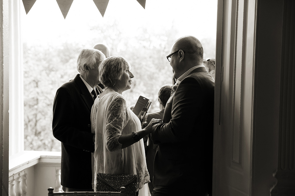 ICA-wedding-2 groom talking to a guest a touching moment