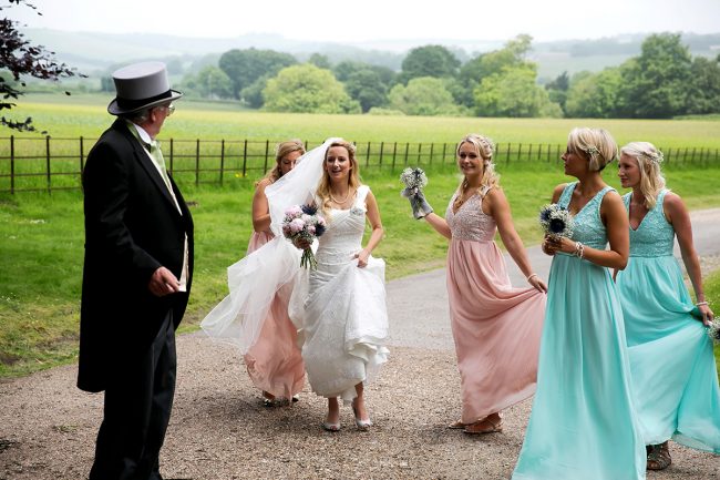 Findon-marquee-wedding-1 bride & bridesmaids walking to the church