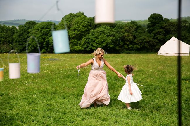 Sussex-wedding-photographer- bridesmaid dancing with flower girl