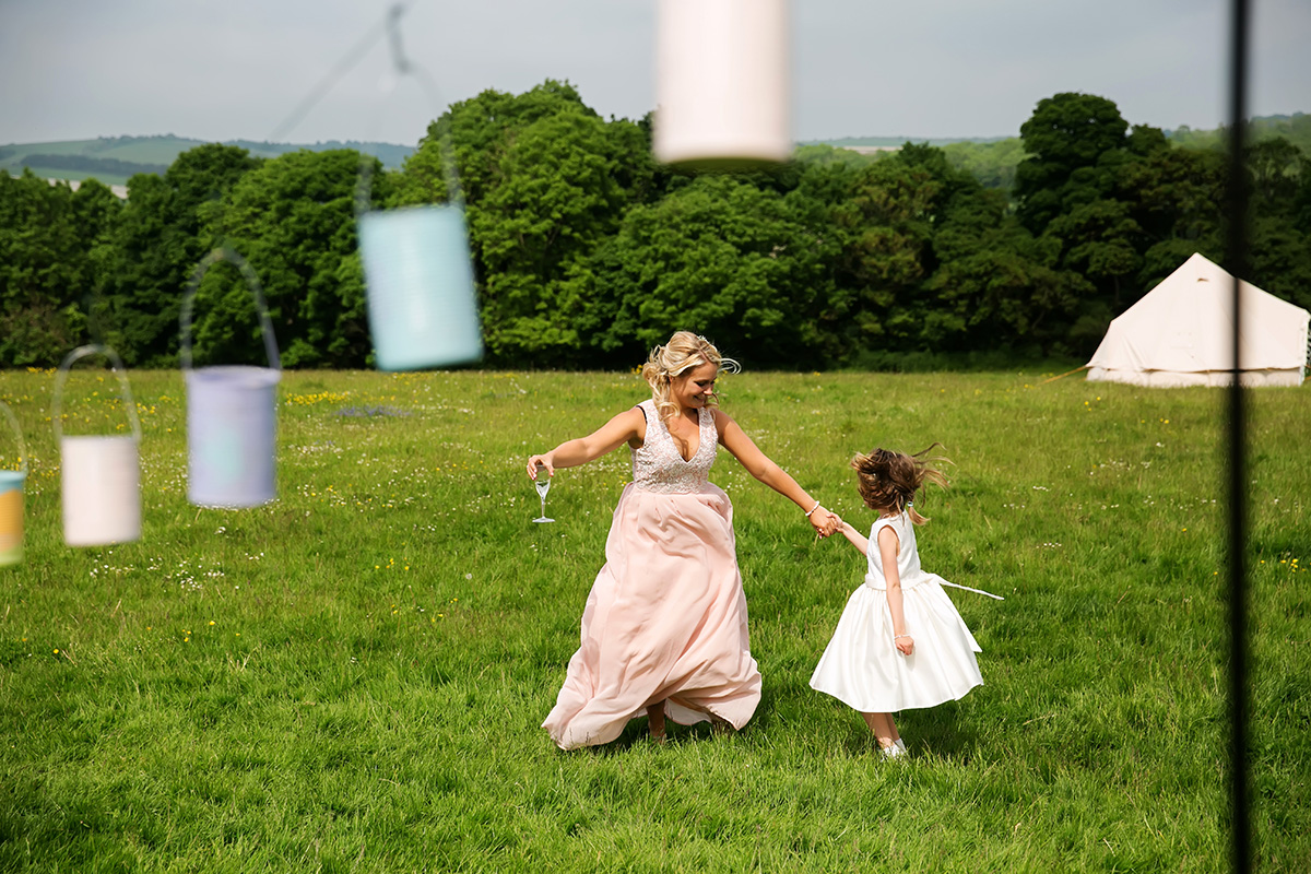 bridesmaid dancing with flower girl