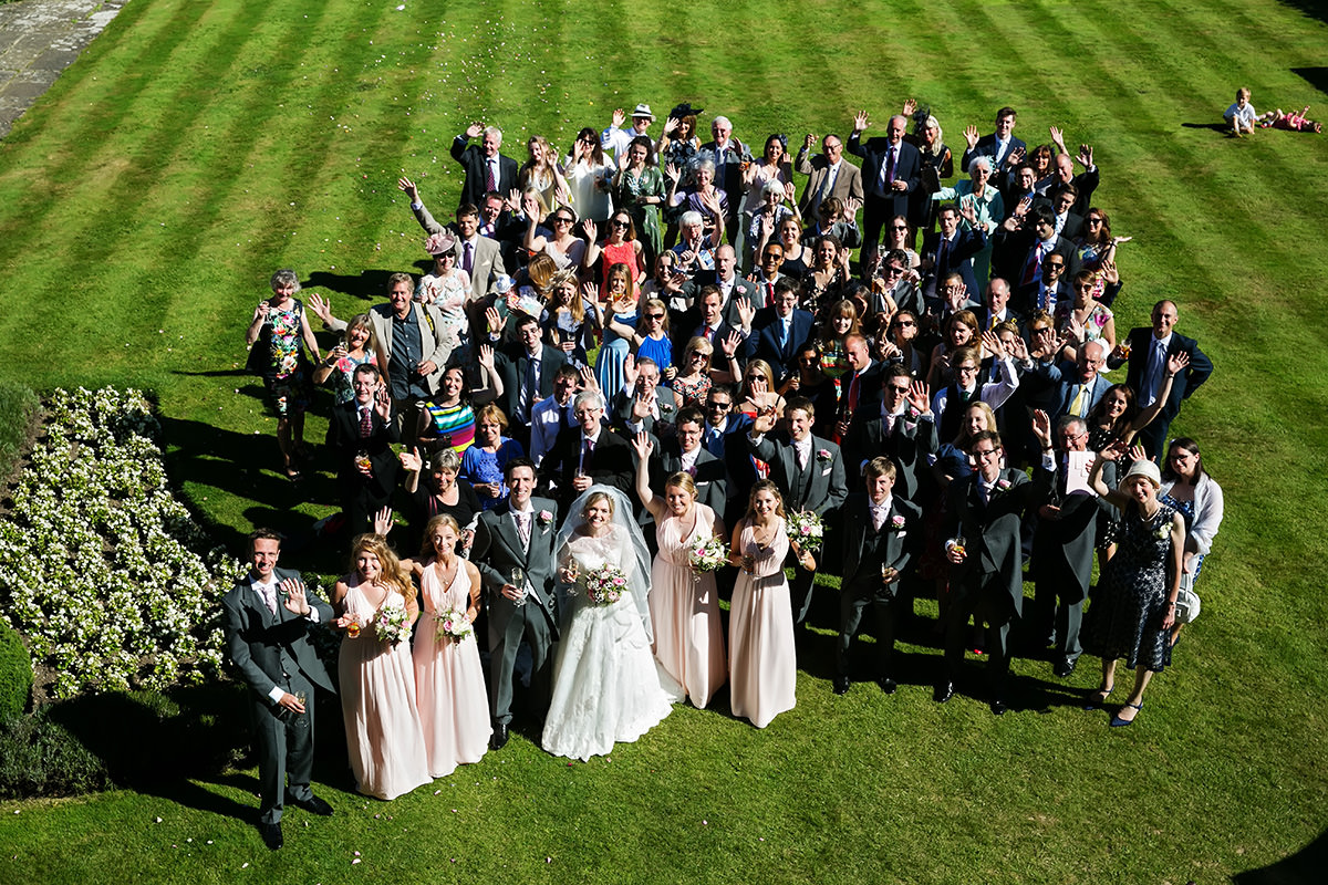 a big group shot at a wedding at Horsted Place