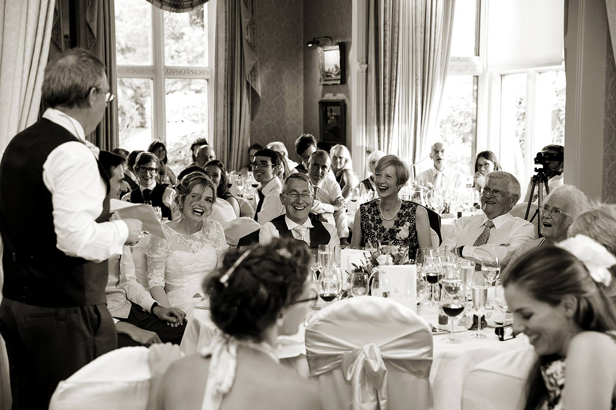 guests laughing at the father of the bride's speech