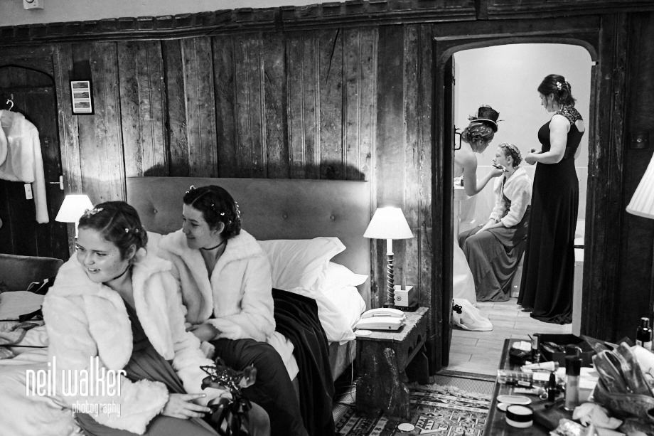 bridesmaids laughing as another has her makeup done