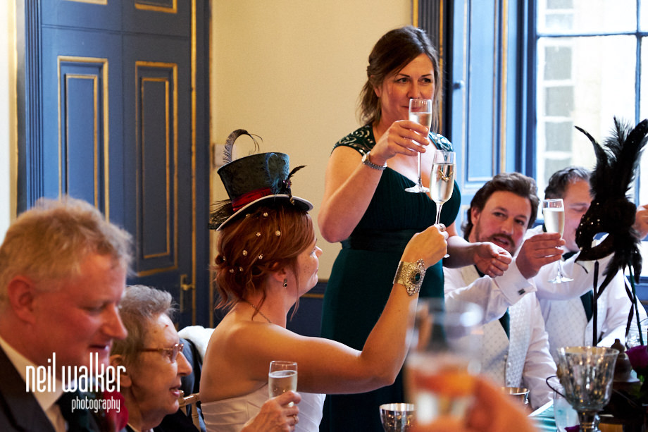 the chief bridesmaid raises a toast during her speech