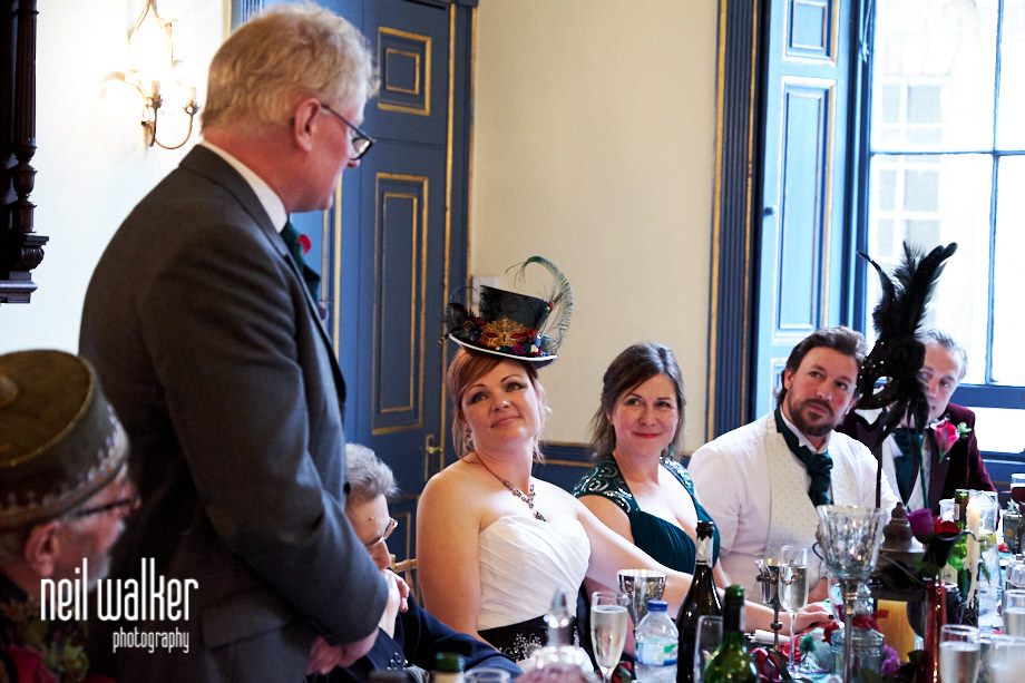 the bride smiles fondly at the groom during his speech