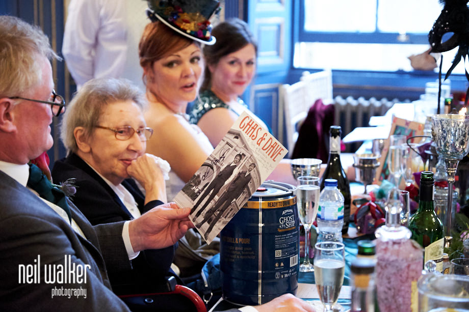 the groom looking at a present from the best man