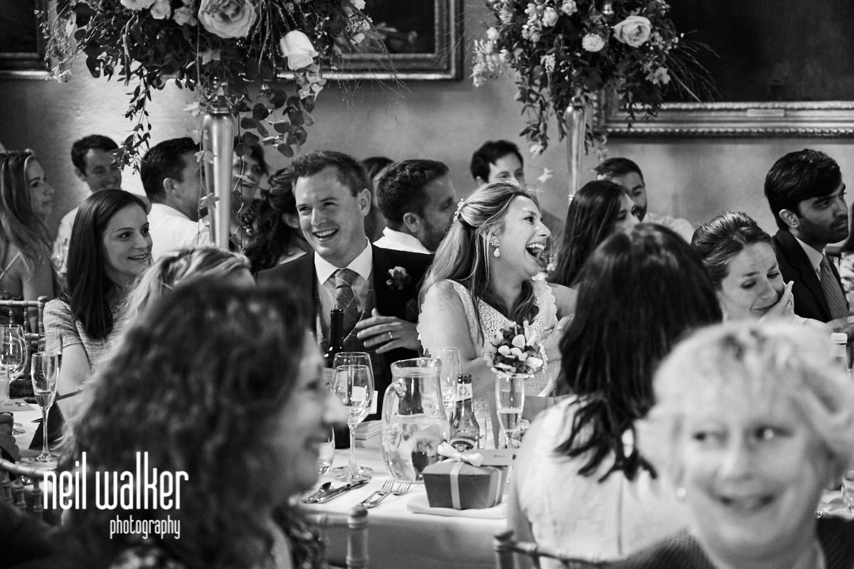the bride laughing at the best man's speech