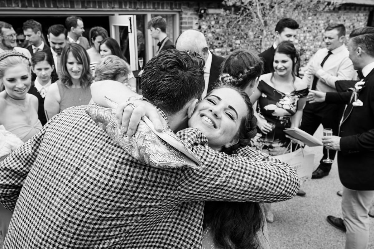 a guest hugging the groom at a wedding