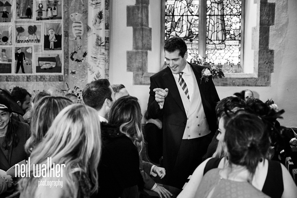 the groom pointing at a guest