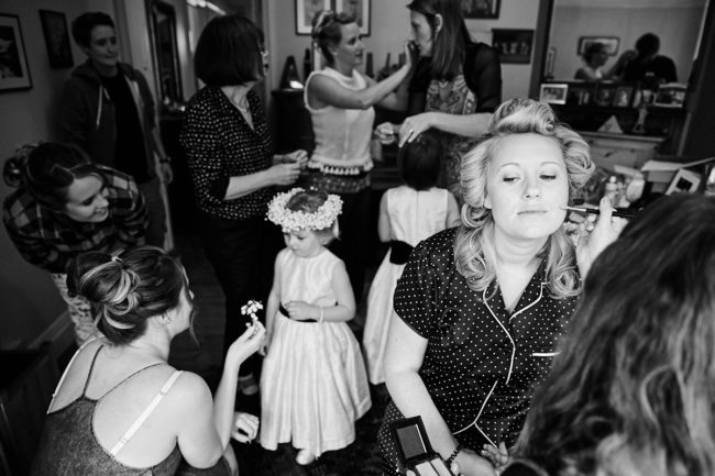 Blog post of Mary the bride having her makeup done while her bridesmaids talk in the background