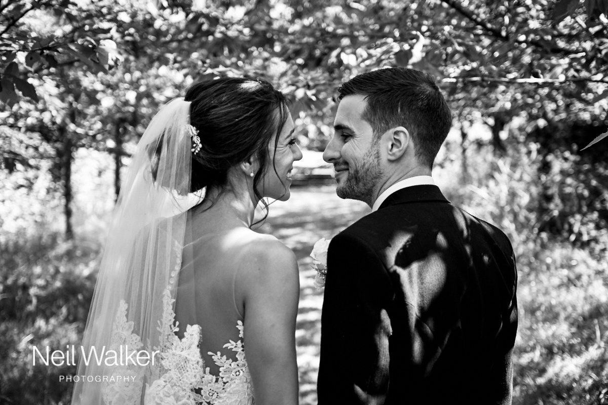 the bride and groom laughing together