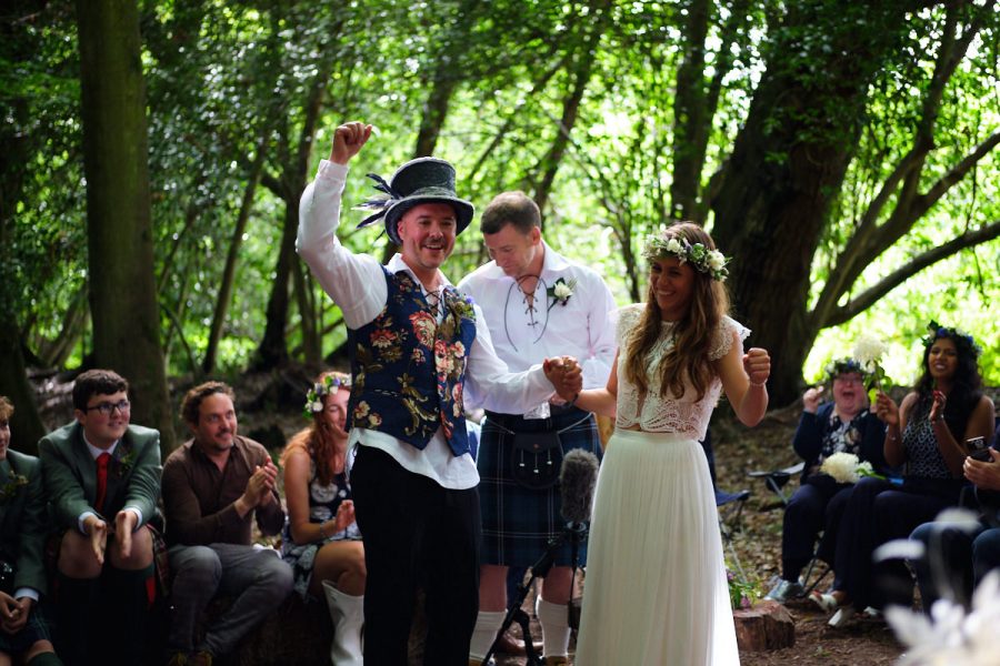 The groom punches the air after the wedding ceremony at Wilderness Wood.